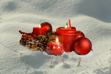 xmas christmas background red balls and candles lighting on the snow in celebration night