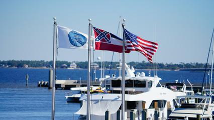 The US and Mississippi flag flying at a marina on the Gulf Coast.