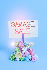 Word writing text Garage Sale. Business photo showcasing sale of miscellaneous household goods often held in the garage Reminder pile colored crumpled paper clothespin reminder blue background