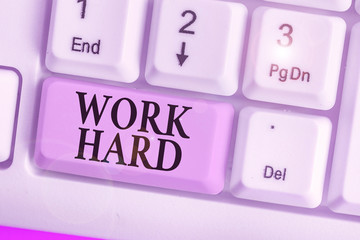 Writing note showing Work Hard. Business concept for Laboring that puts effort into doing and...