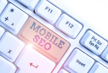 Handwriting text writing Mobile Seo. Conceptual photo process of optimizing a website to rank for mobile searches White pc keyboard with empty note paper above white background key copy space