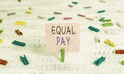 Writing note showing Equal Pay. Business concept for Rights that individuals in the same workplace be given equal pay Green clothespin white wood background reminder office supply