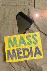 Obraz premium Writing note showing Mass Media. Business concept for Group showing making news to the public of what is happening Smartphone device inside trousers front pocket note paper