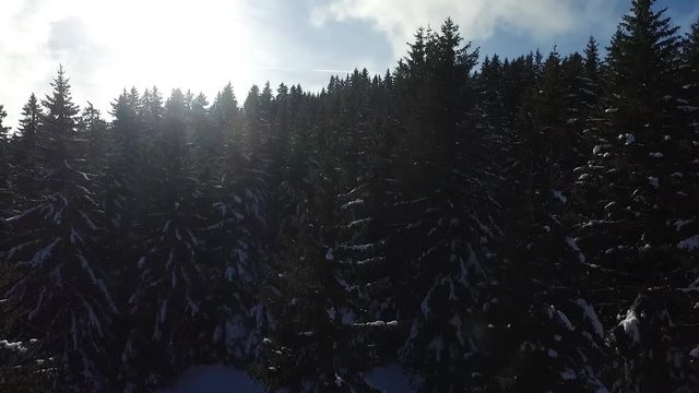 Flying during winter with snow at a sunny day at the Jura in Switzerland