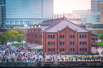 People are relaxing near the Famous red brick house in Yokohama port.