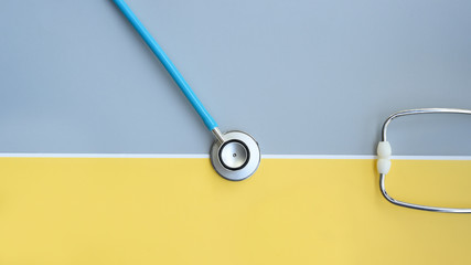 close up of stethoscope on gray and yellow background     