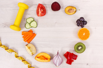 Natural fruits and vegetables, dumbbell with tape measure, healthy lifestyles concept