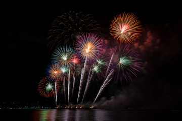 Colorful fireworks of various colors at night with celebration and anniversary concept