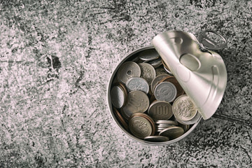 Japanese currency coins in tin can