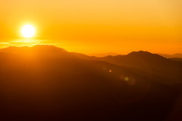 Mountains in sunrise,fog on sunrise,mist over mountain during sunrise