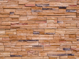 Decorative brown stone setting. Cut stone wall texture.