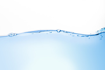 Close-up of blue water waves and bubbles on a white background.