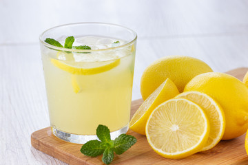 Fresh citrus lemonade water with lemon, mint and ice. Refreshing cold drink.