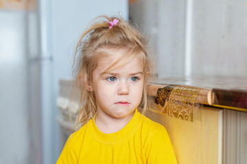 Portrait of a little sad girl indoors