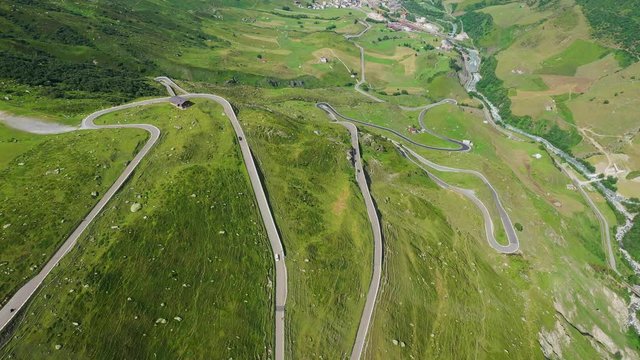 The bending roads of a Swiss pass in the alps - view from above - aerial photography