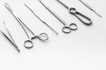 Instruments for plastic surgery on white background flat lay pattern copy space