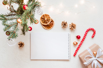 Empty Notebook with wish list and christmas decor on white table. Copy space for greeting text or lettering