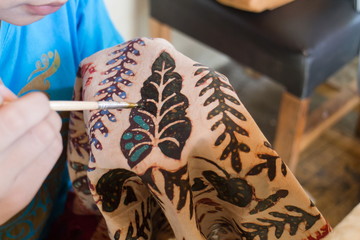 Close up of hand painting Indonesia batik.