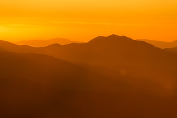 Fototapeta na wymiar Mountains silhouette at colorful sunset