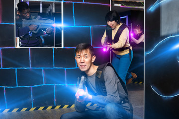 Chinese man during lasertag game in dark room