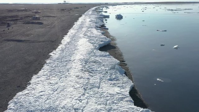 The sea coastal strip covered with ice and snow. Place of shooting northerly coast of the Bering Sea, Chukchi region, Russia.