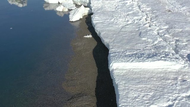 The sea coastal strip covered with ice and snow. Place of shooting northerly coast of the Bering Sea, Chukchi region, Russia.