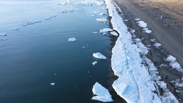 The sea coastal strip covered with ice and snow. Place of shooting northerly coast of the Bering Sea, Chukchi region, Russia.