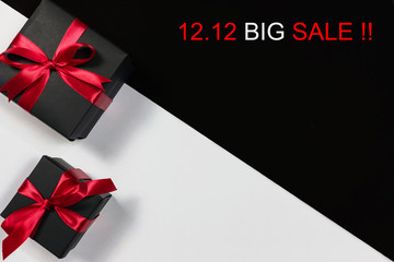 Online shopping of China.,Top view of black christmas gift boxes with red ribbon and text on black and white background with copy space for text., 12.12 single day sale concept and advertisement.