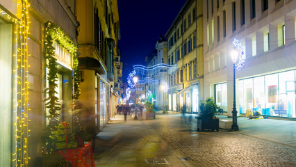 Fototapeta na wymiar New Year's illuminated streets of Parma at evening, Italy