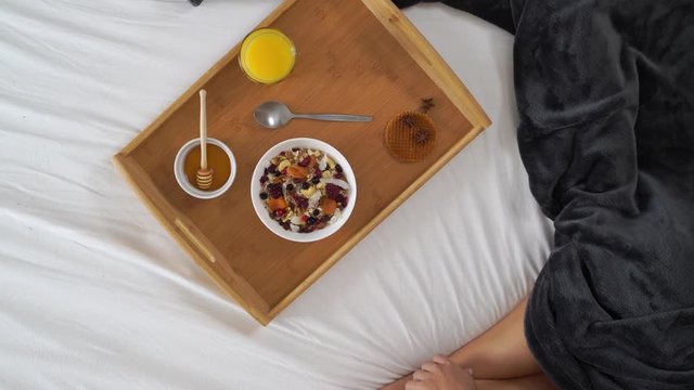 Image of woman drinking coffee during the breakfast at bed.