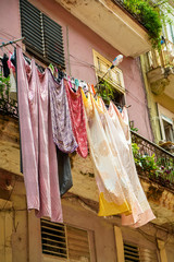 Clean linens drying on a rope outdoors in city. Cuba 