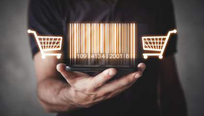 Businessman showing bar code with shopping cart. Warehouse, logistic, shopping