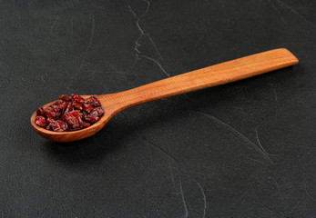 Dry barberry in spoon