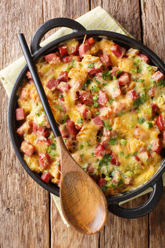 Tasty American Breakfast Strata With Ham, Bread, Onions, Cheese And Eggs Close-up. Vertical Top View