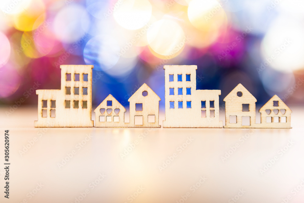 Wall mural Wooden house craft design over blurred colorful bokeh background, city life concept, house and property business