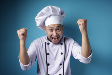 Naklejka premium Happy Proud Asian Chef Shows Winning Gesture