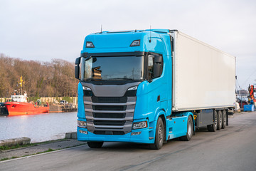blue truck delivery commercial cargo with refrigerator trailer. Copy space. © Igor