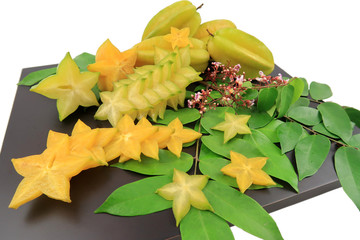 Fresh Carambola or Star Fruits which there are many slicing in star shape decorate on wooden tray...