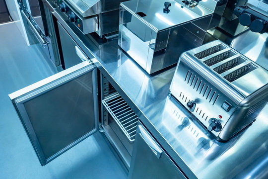 Equipment for restaurants. Kitchen is on the food front. Toaster. Deep-fried Steel kitchen cabinet. Open cupboard in the restaurant kitchen. Equipment for horeca. Catering Enterprise. Catering