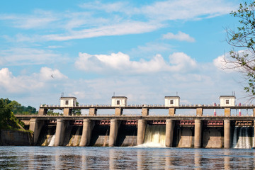 dam on the river against the blue sky in summer