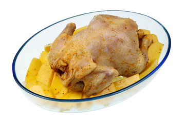 Pickled with honey and ginger raw  chicken lies on the slices of potatoes in a heat-resistant glass baking dish isolated