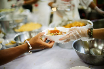 Food Sharing Society: Volunteers are sharing food to hungry people in society.