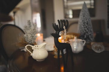 Black deer statuette. New year and Christmas gift for a woman. Golden bracelet with zirconium glass stones.
