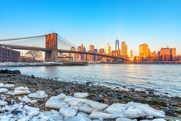 Brooklyn bridge East river and Manhattan at winter sunrise, New York City