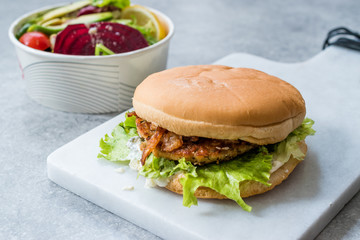 Fast Food Menu Salmon Burger with Take Away Salad in Plastic Box.