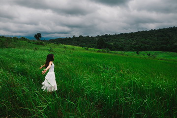 happy girl in a spring field, enjoying nature, beautiful woman in meadow,Freedom concept background.