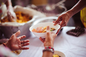 Social hunger: Volunteers provide food assistance to poor people who need food.