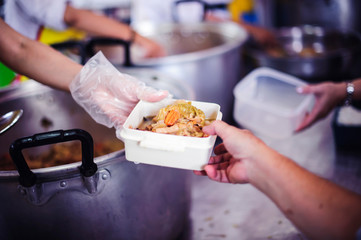 Social hunger: Volunteers provide food assistance to poor people who need food.