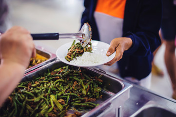 Social hunger: Volunteers provide food assistance to poor people who need food.