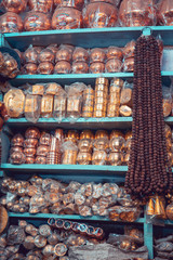 Street shops in Varanasi: metallic urns the pilgrims use to collect the water of the holy Ganges river. Indian lifestyle.